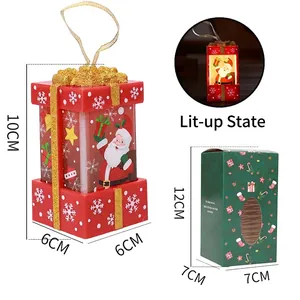 Close-up of LED light-up red Christmas gift box ornament with Santa Claus and size details