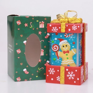 Christmas gift set with gingerbread man ornament and festive green gift box