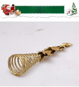 Macro detail of golden glitter spiral Christmas tree topper with leaf-shaped accents