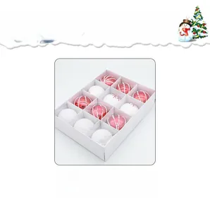 Detail view of 12 red and white Christmas balls with glitter and matte finishes in a box