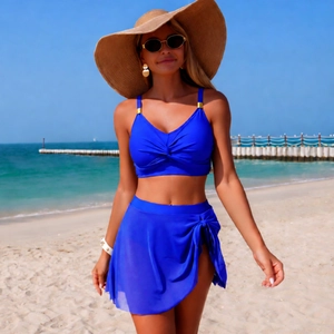 Detail view of royal blue two-piece bikini with a twisted bust top and side-tie swim skirt
