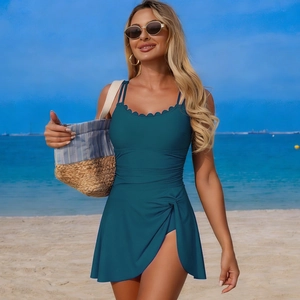 Detail of scalloped neckline and turquoise one-piece swimsuit with ruched waist texture