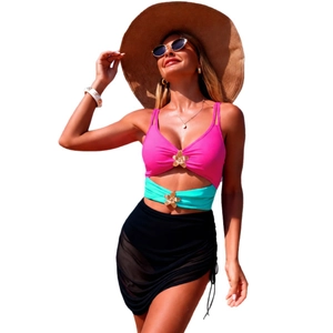Three-piece bikini set with pink top, green belt and black mesh skirt on a model