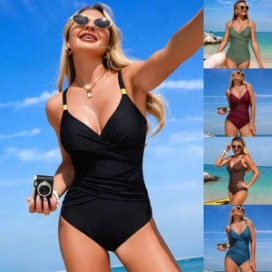 Detail of slim-fit one-piece swimsuit featuring tummy-control pleats and metal rings