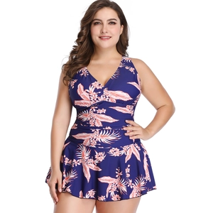 Plus size swimdress for women with tropical floral print and tummy control design