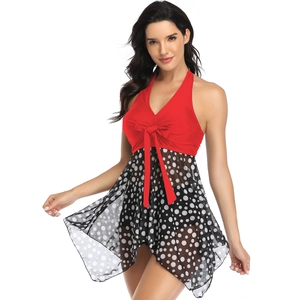 Red halter neck bikini with black polka dot mesh skirt for a stylish beach look
