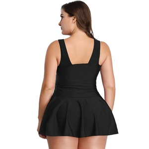 Rear view of plus size black swim dress featuring wide straps and pleated skirt hem