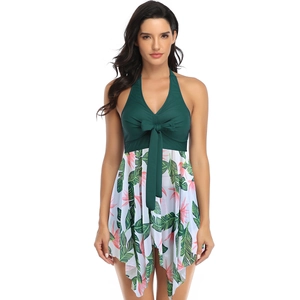 Detail of plus size swimdress with dark green halter neck and tropical floral skirt