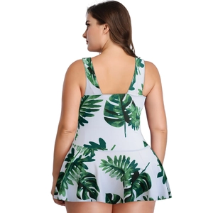 Detail view of plus size white swimdress with tropical green monstera leaf print and U-back