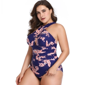 Detail of plus size one-piece swimsuit with crisscross neck and dark blue floral pattern