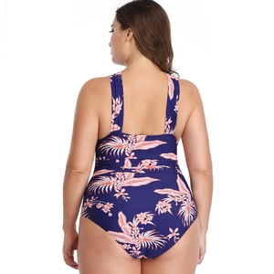 Back view of one-piece swimsuit featuring tropical floral prints and U-shaped back design