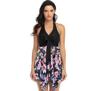 Detail of plus size halter neck swimsuit featuring black V-neck top and floral mesh skirt
