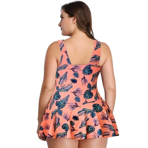 Detail showing tropical leaf print pattern on the back of a pink plus size swimdress