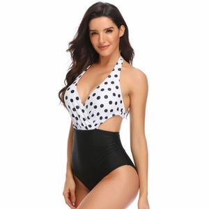 Detail view of one-piece swimsuit featuring black polka dots and side cutouts