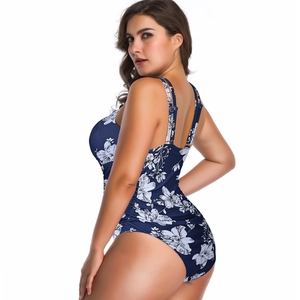 Detail of blue one-piece swimsuit with white floral print and side ruching effects