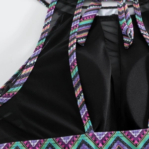 Detail of black honeycomb mesh swimsuit with colorful ethnic geometric print straps