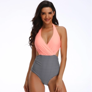 Detail of cross deep V-neck halter one-piece swimsuit with coral top and striped bottom