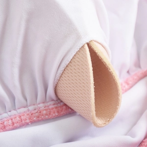 Detail of white swimsuit with pink stitching and removable beige padding insert