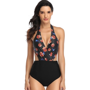 Close-up of floral print halter neck and side cutout details on a one-piece swimsuit