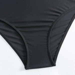 Detail of high-elastic black swimwear fabric showing premium double-stitch sewing quality