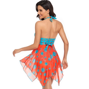 Back view of orange swimsuit dress with blue polka dots and neck tie detail