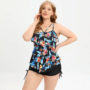 Detail of plus size tankini featuring vibrant tropical floral print and tiered ruffles