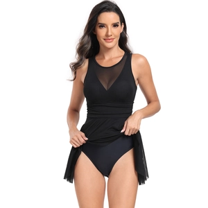 Detail of black one-piece swimsuit with mesh neckline and pleated skirt design
