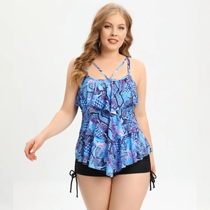 Detail of plus size tankini featuring blue snake print and tiered ruffle layers