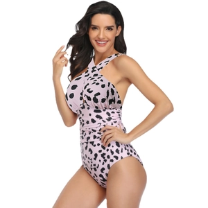 Pink leopard print one-piece swimsuit with cross-neck halter design and slimming fit