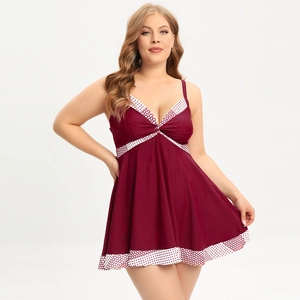 Detail of wine red V-neck swimsuit with white polka dot trim and pleated bust design
