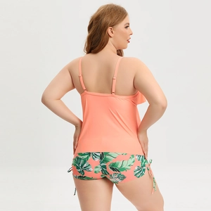 Detail of coral plus size tankini back view with tropical leaf print swim shorts