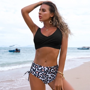 Detail of high waist leopard print bikini bottom with side drawstring and black top