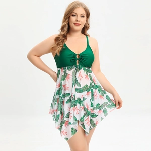 Detail of plus size tankini with tropical leaf print skirt and dark green lace-up top