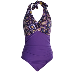Detail of paisley halter neck swimsuit featuring ruched purple fabric and twist front