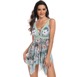 Detail of V-neck cross-strap design and tropical leaf print on light green tankini top