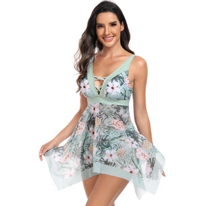 Detail of mint green floral swimsuit with criss-cross neckline and sheer mesh skirt hem