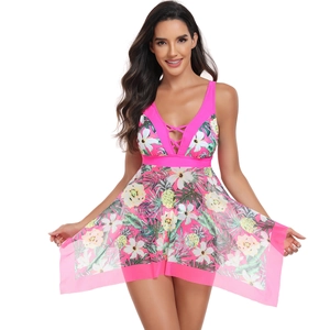 Detail of hot pink V-neck swimsuit with tropical floral prints and pineapple pattern