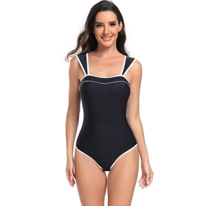 Detail view of black one-piece swimsuit featuring elegant white contrast piping and dual straps