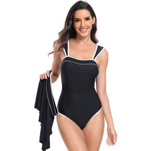Detail view of black one-piece swimsuit with white piping and matching sarong skirt
