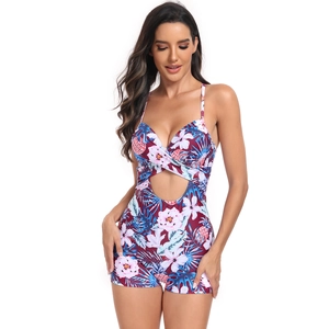 Detail of floral one-piece swimsuit featuring tummy cutout and pineapple pattern
