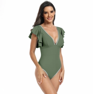 Close-up detail of double layered ruffle sleeves and white sawtooth lace on green swimsuit