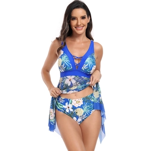 Detail view of tropical floral print tankini set with V-neck cross straps and mesh skirt