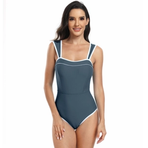 Close-up of sporty grey-blue one-piece swimsuit with stylish white contrast piping details