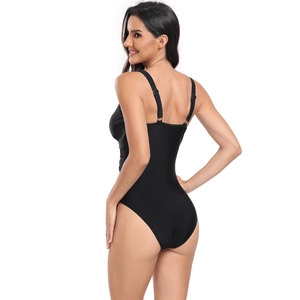Detail of adjustable thin straps and high-cut back design on a black one-piece swimsuit