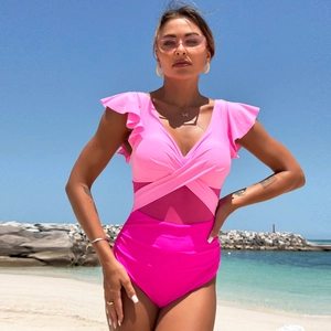 Detail of pink one-piece swimsuit with ruffle sleeves and purple mesh waist panel