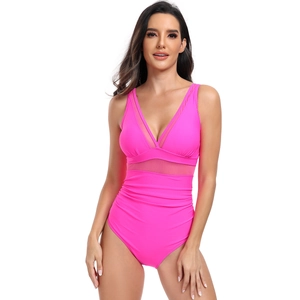 Detail view of the hot pink one-piece swimsuit featuring mesh cutouts and slimming waist ruched