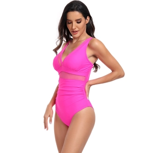 Detail of pink one-piece swimsuit with V-neckline, mesh panels and ruching details