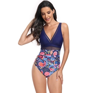 Detail of high-waisted one-piece swimsuit featuring deep V-neck and ethnic floral prints