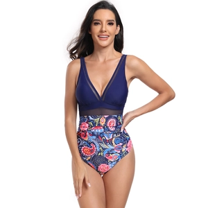 Detail of one-piece swimsuit featuring mesh V-neck and vibrant paisley floral print