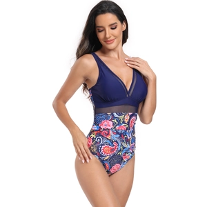 Detail of one-piece swimsuit with V-neck mesh insert and vibrant floral paisley patterns